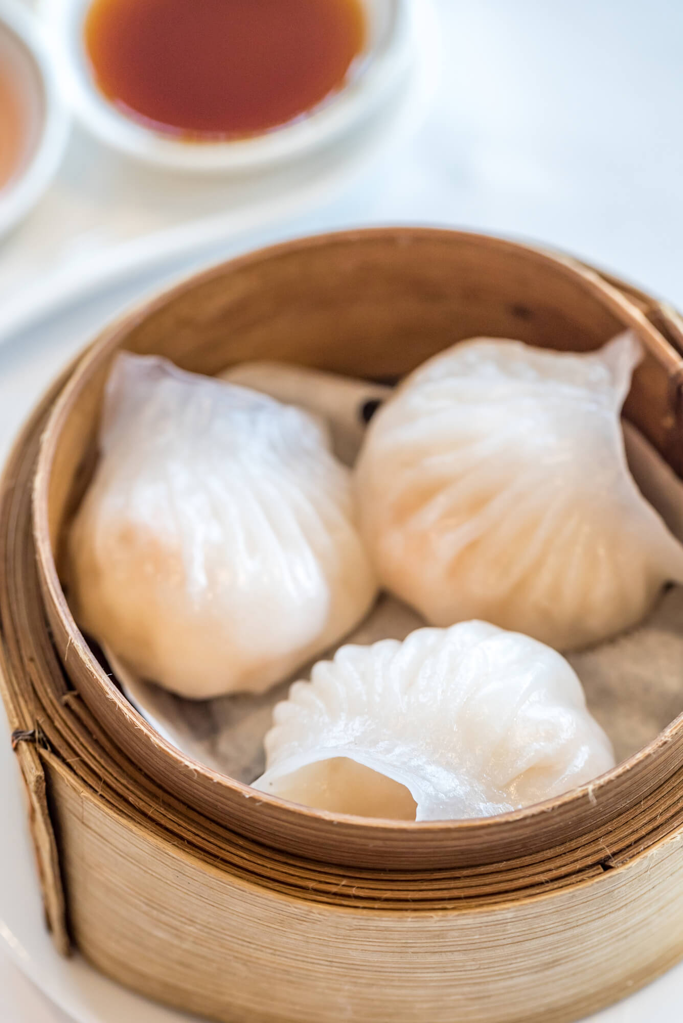 Har Gow Cantonese shrimp dumplings famous in dim sum, presented in a traditional bamboo steamer