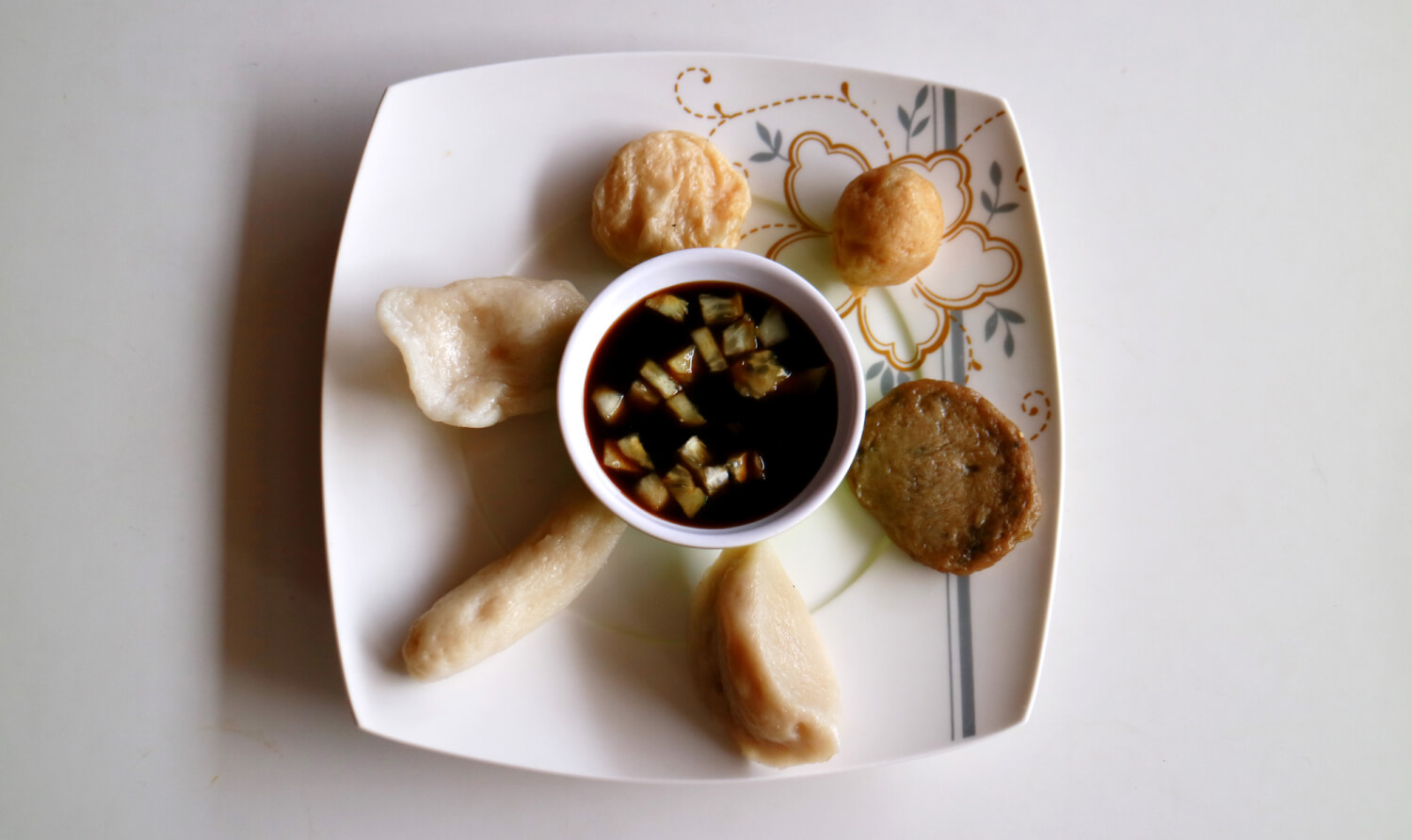 A plate of varied Pempek, delicious Indonesian fish dumplings