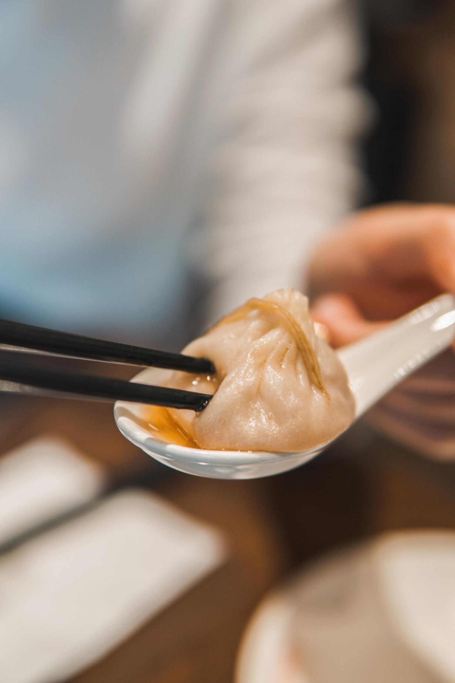 A juicy Xiao Long Bao pork dumpling from China filled with ground pork and hot savoury broth